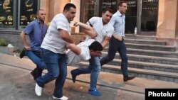 Armenia - Plainclothes police officers arrest a protester on Marshal Bagramian Avenue, Yerevan, 23Jun2015.