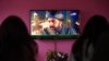 A family watches the Turkish drama series Dirilis: Ertugrul on Pakistani TV during the holy month of Ramadan in Islamabad.