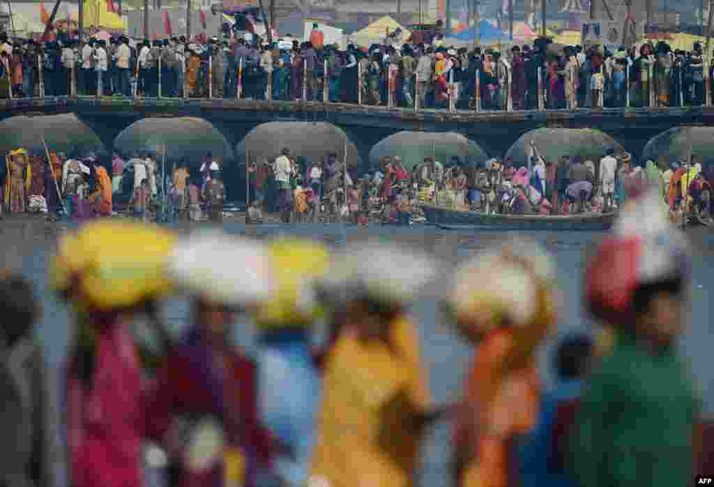 Devotees converge on the Sangam -- the confluence of the sacred Yamuna, Ganges, and Sarawati rivers -- in Allahabad, India during the world's largest religious festival, known as Maha Kumbh. (AFP/Roberto Schmidt)