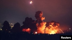 Smoke rises following an explosion over Beirut's southern suburbs after an air strike late on October 3. 