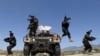 Afghan soldiers patrol outside their military base on the outskirts of Kabul on May 9.