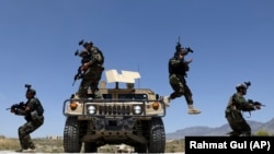 Afghan soldiers patrol outside their military base on the outskirts of Kabul on May 9.