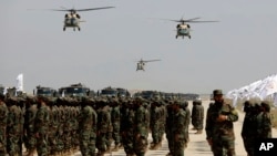 US-made Black Hawk helicopters fly during a military parade in August 2024 at Bagram to mark the third anniversary of the withdrawal of US-led troops from Afghanistan.