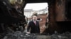 British Defense Secretary John Healey looks through a destroyed Russian military vehicles on St. Michael's Square in Kyiv on December 18.