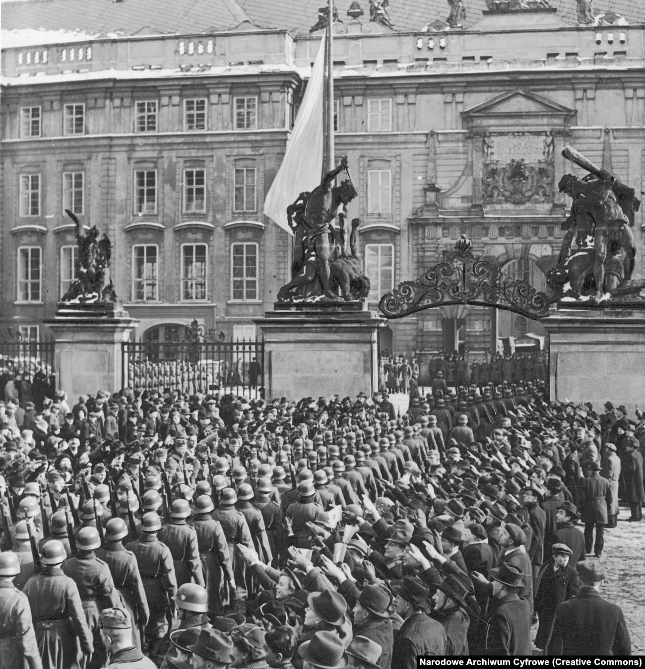 Nazi troops march into Prague Castle as crowds salute them in March 1939.