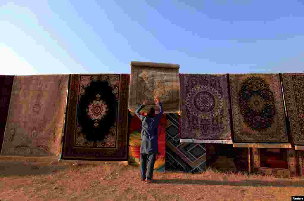 A man sells carpets on a roadside in Islamabad, Pakistan. (Reuters/Faisal Mahmood)