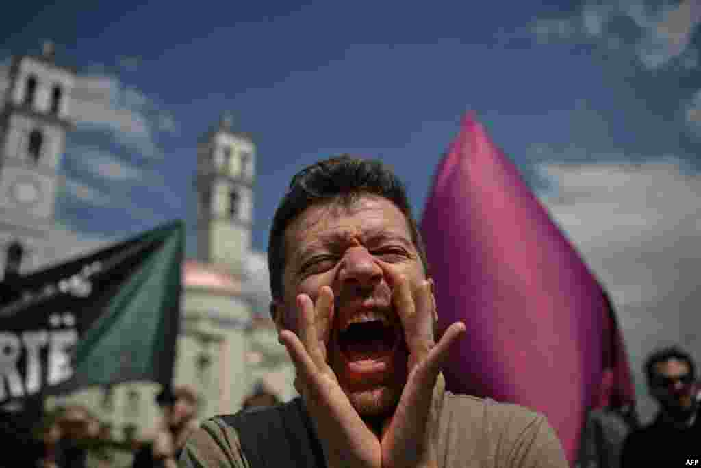 A protester shouts slogans during a Labor Day rally in the Kosovar capital, Pristina, on May 1,