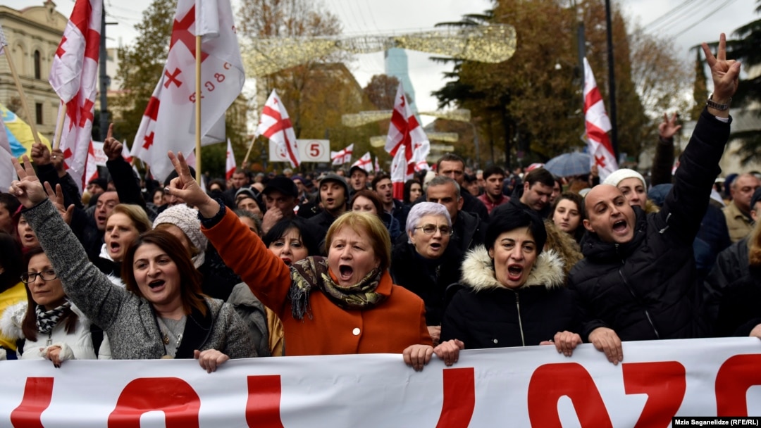 Protesters march to support former President Mikheil Saakashvili in Tbilisi on December 6.