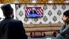 Afghan men watch a television broadcast of Donald Trump's victory speech at a restaurant in Kabul on November 6.