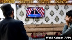 Afghan men watch a television broadcast of Donald Trump's victory speech at a restaurant in Kabul on November 6.