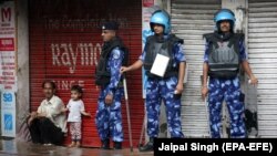 Indian security personnel stand guard on the streets of Jammu.