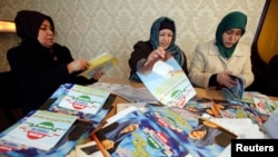 Supporters of the Islamic Renaissance Party of Tajikistan sort preelection leaflets at party headquarters in the capital, Dushanbe, in February.