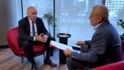 Former world chess champion Garry Kasparov speaks to RFE/RL's Mumin Shakirov in Warsaw on October 11. 