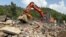 Recovery crews hunt for bodies among the ruins of a building in the village of Bishonai in Pakistan's Buner district on August 19 after floods swept through the region. 