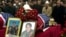People pay their last respects in February 2002 to the three Bytyqi brothers -- Ylli, Agron, and Mehmet -- who were found the previous June in a grave with more than 70 other Kosovo Albanians in Serbia's Petrovo Selo.