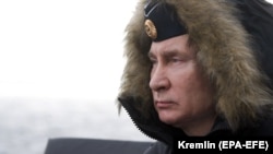 Russian President Vladimir Putin attends joint drills of the Northern and Black Sea fleets on board the Russian guided-missile cruiser Marshal Ustinov in the Black Sea, off the coast of Crimea, on January 9.