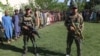 Afghan security officials present civilians who were released during an operation at a Taliban prison in Pashtun Zarghon district of Herat on May 25.