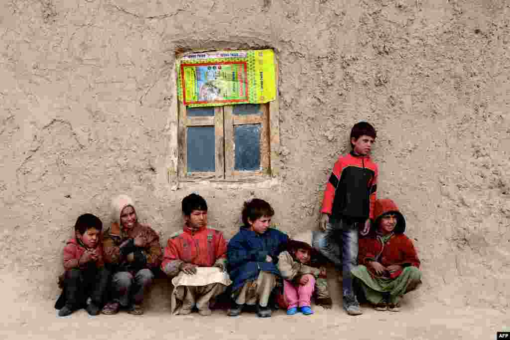 Afghan children sit near their home in Herat. (AFP/Aref Karimi)