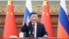 Chinese President Xi Jinping waves during a meeting with Russian President Vladimir Putin via video link in Beijing on December 30, 2022.