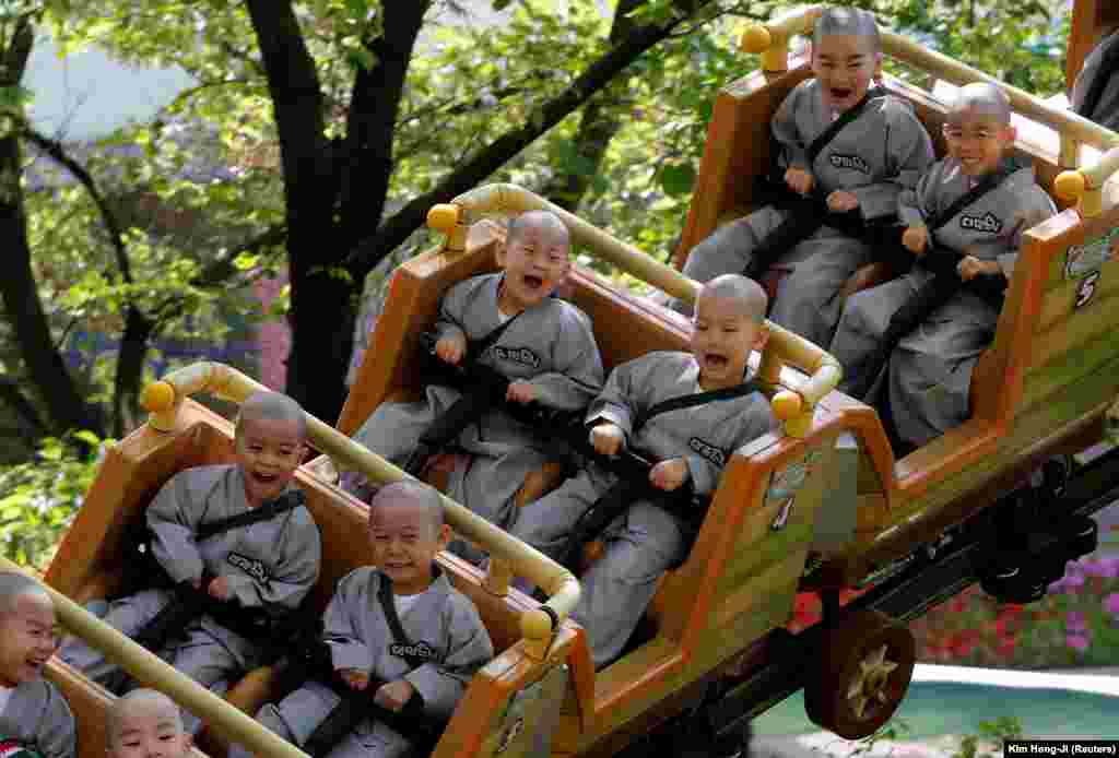 Boys who are experiencing the lives of Buddhist monks by staying in a temple for two weeks as novice monks enjoy a ride at Everland amusement park in Yongin, South Korea. (Reuters/Kim Hong-Ji)