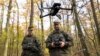 A recruit for the German armed forces controls a drone during a military exercise in November 2025.