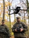 A recruit for the German armed forces controls a drone during a military exercise in November 2025.