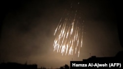 A photo shows what appears to be white phosphorus incendiaries landing during regime bombardment in Douma, one of the few remaining rebel-held pockets in Eastern Ghouta on the outskirts of the capital Damascus, March 23, 2018