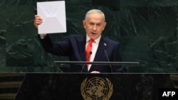 Israel's Prime Minister Benjamin Netanyahu holds up a Starlink device as he speaks during the 81st UN General Assembly in New York, on September 24, 2026. 