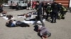 Rescue personnel tend to victims in the aftermath of a rocket attack on the railway station in Kramatorsk on April 8, 2022. Fifty-eight civilians were killed.
