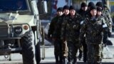 Ukraine -- Ukrainian army soldiers walk outside the Ukrainian military base blocked by Russian forces in Perevalnoye, near Simferopol, March 17, 2014