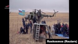 Members of a search-and-rescue team at the landing site of the Soyuz MS-16 space capsule in a remote area outside Zhezkazgan, Kazakhstan, on October 22