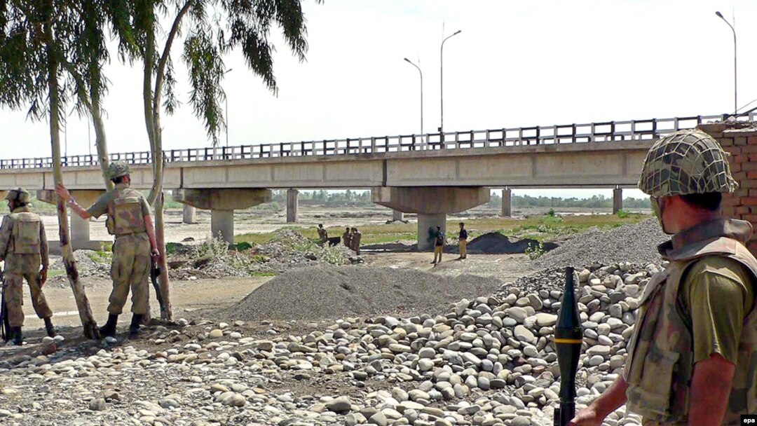 Pakistani soldiers inspect a bridge over the Kurram River. Can development go forward when military operations are driving people from their homes?