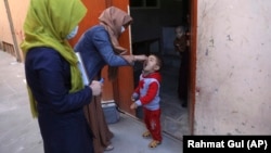 A health worker administers a polio vaccine to a child during a previous campaign in Kabul.