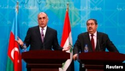 Azerbaijani Foreign Minister Elmar Mammadyarov (left) speaks during a joint news conference with Iraqi counterpart Hoshyar Zebari in Baghdad on February 10.