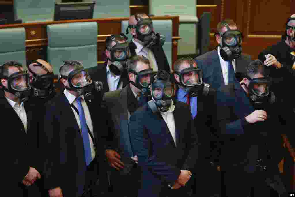 Kosovar police officers wear gas masks during a plenary session of Kosovo's parliament in Pristina. Opposition lawmakers have often thrown tear gas to protest against agreements that have been reached in Brussels during an EU-brokered dialogue between Kosovo and Serbia. (epa/Valdrin Xhemaj)