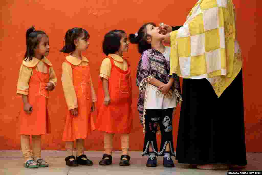 A child receives polio vaccine drops during a door-to-door vaccination campaign in Peshawar, Pakistan. Pakistan has commenced a nationwide anti-polio campaign that aims to vaccinate 45 million children under 5 years old across 71 affected districts. The disease remains endemic only in Pakistan and Afghanistan.