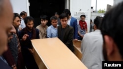 Relatives carry coffin of a victim at a hospital after a suicide attack in Kabul, Afghanistan June 11, 2018. REUTERS/Mohammad Ismail