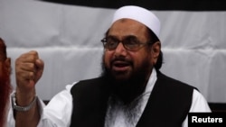 Hafiz Saeed, head of the Jamaat-ud-Dawa organisation and founder of Lashkar-e-Taiba (LET), gestures during a news conference in 2014.