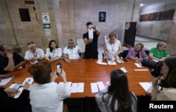 Election officials count votes in the parliamentary election in Yerevan on June 7.