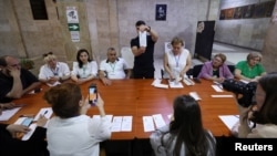 Election officials count votes in the parliamentary election in Yerevan on June 7.