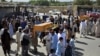 Men carry the coffin of a relative who died during a raid on a house in the Chaparhar district of Nangarhar Province on May 29.