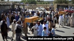 Men carry the coffin of a relative who died during a raid on a house in the Chaparhar district of Nangarhar Province on May 29.