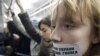 A woman takes part in a flash mob in the Moscow subway, with a sticker on her mouth saying, &quot;They stole our voices.&quot; (ITAR-TASS/Aleksandr Sorin)