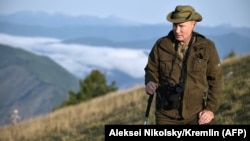 Russian President Vladimir Putin strikes a pose on a mountainside during a vacation in the remote Tuva region in southern Siberia in late August.