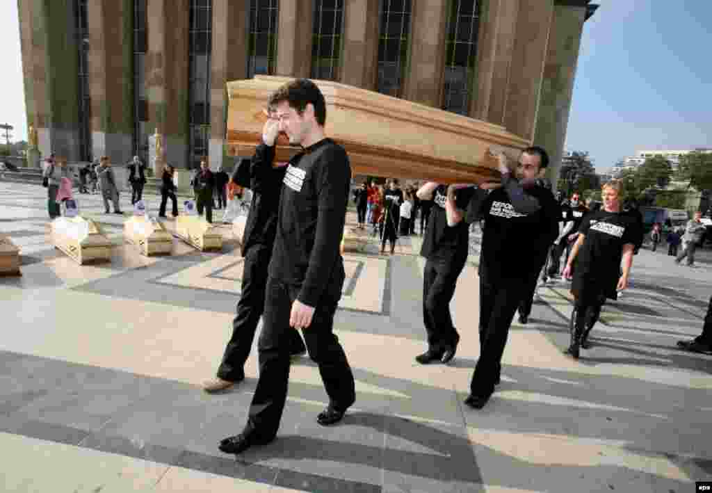 Activists with the media rights group Reporters Without Borders carry a mock coffin at an October 5 demonstration in Paris to commemorate 18 journalists killed in Russia since President Vladimir Putin came to power. (photo: epa)