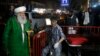 Afghan religious scholars wait outside the Emergency hospital after a suicide attack targeted a religious gathering at a wedding hall in Kabul on November 20.