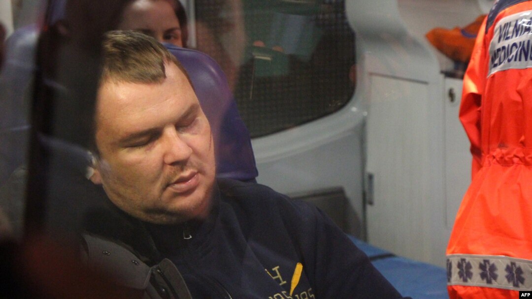 Ukrainian opposition activist Dmitry Bulatov sits in an ambulance at the airport in Vilnius, where he arrived for treatment on February 2.