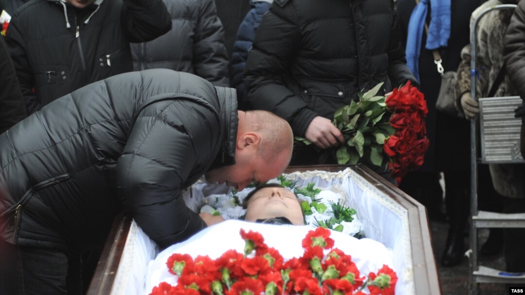 Mikhail Markelov, the brother of slain human rights lawyer Stanislav Markelov, pays his last respects at his brother's funeral in Moscow in 2009.