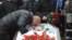 Mikhail Markelov, the brother of slain human rights lawyer Stanislav Markelov, pays his last respects at his brother's funeral in Moscow in 2009.