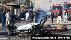 Afghan security forces inspect the site of a blast in Kabul on October 27.